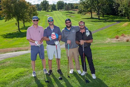 golfers posing for photo