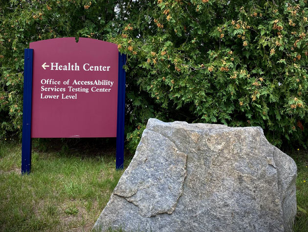 Health Center Office of AccessAbility Services Testing Center Lower Level entrance sign and surrounding foliage