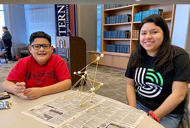 students at table with science project