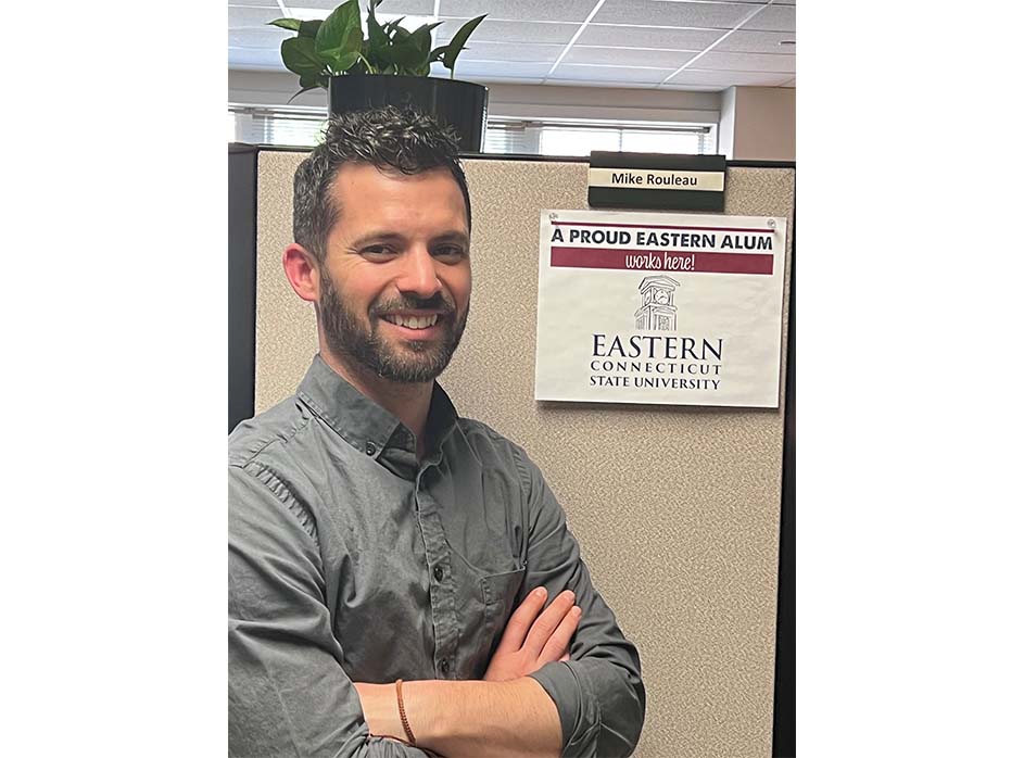 Mike, an alumni holding Eastern spirit poster